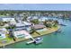 Aerial view of a waterfront community, showing modern homes along a canal with private docks and a pool at 3638 San Remo Ter, Sarasota, FL 34239
