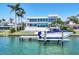 Modern waterfront home featuring a private boat dock with lift, pool and lush landscaping at 3638 San Remo Ter, Sarasota, FL 34239