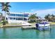 Upscale waterfront home showcasing a private dock with boat lift, landscaped grounds, and modern design at 3638 San Remo Ter, Sarasota, FL 34239