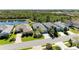 Aerial view of neighborhood with lush greenery and pond at 5023 Tobermory Way, Bradenton, FL 34211