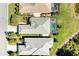 Aerial view of home with pool, water view, and lush landscaping at 5023 Tobermory Way, Bradenton, FL 34211