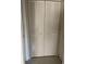 Bedroom closet with louvered doors and neutral color palette at 7030 W Country Club N Dr # 128, Sarasota, FL 34243