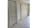Hallway view featuring tiled floor, closet space and neutral walls at 7030 W Country Club N Dr # 128, Sarasota, FL 34243