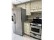 Bright kitchen features stainless steel appliances, tile floors, and granite countertops at 7030 W Country Club N Dr # 128, Sarasota, FL 34243