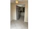 Open view into the kitchen featuring stainless steel appliances and tile flooring at 7030 W Country Club N Dr # 128, Sarasota, FL 34243