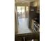 View of the kitchen features stainless steel appliances and an adjacent patio with outdoor furniture at 7030 W Country Club N Dr # 128, Sarasota, FL 34243