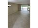 Spacious living room featuring tile floors and sliding glass doors to a screened in patio at 7030 W Country Club N Dr # 128, Sarasota, FL 34243