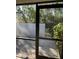 View from screened patio showcasing lush landscaping and garden at 7030 W Country Club N Dr # 128, Sarasota, FL 34243