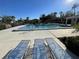 Community pool with lounge chairs and clear blue skies at 7030 W Country Club N Dr # 128, Sarasota, FL 34243