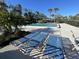 Relaxing pool area with plenty of lounge chairs, perfect for enjoying the sunny weather at 7030 W Country Club N Dr # 128, Sarasota, FL 34243