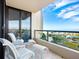 Relaxing balcony area with comfortable seating overlooking the ocean and lush landscaping enhancing the outdoor living space at 1211 Gulf Of Mexico Dr # 301, Longboat Key, FL 34228