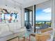 Inviting living room opens to a balcony with ocean views, sofa, chairs, table, and statement artwork at 1211 Gulf Of Mexico Dr # 301, Longboat Key, FL 34228