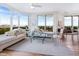 Bright living room with expansive windows, stylish furnishings, and scenic views creating a relaxing ambiance at 1211 Gulf Of Mexico Dr # 301, Longboat Key, FL 34228