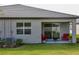 Covered patio and backyard featuring two red chairs and a fire pit perfect for outdoor relaxation at 12525 Lily Quartz Loop, Parrish, FL 34219