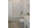 Bright bathroom featuring a shower-tub combo, white tile, and a modern vanity at 12525 Lily Quartz Loop, Parrish, FL 34219