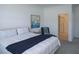 Inviting bedroom showcasing a bed with a throw blanket and neutral walls, accented with stylish decor at 12525 Lily Quartz Loop, Parrish, FL 34219
