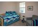 Bright bedroom features a twin bed with seaside themed comforter, soft carpet, and matching throw pillows at 12525 Lily Quartz Loop, Parrish, FL 34219