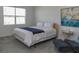 Cozy bedroom featuring a comfortable bed with a blue blanket and neutral decor, creating a relaxing atmosphere at 12525 Lily Quartz Loop, Parrish, FL 34219