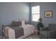 Cozy bedroom with a daybed, comfortable chair, and natural light from the window at 12525 Lily Quartz Loop, Parrish, FL 34219