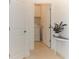 Hallway with views to laundry room and a console table with decor at 12525 Lily Quartz Loop, Parrish, FL 34219