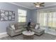 Bright, cozy living room with comfortable seating, modern decor, and view to the outside at 12525 Lily Quartz Loop, Parrish, FL 34219