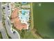 Stunning aerial of the clubhouse, pool, playground, tennis and bocce courts near a picturesque lake at 20296 Bandera Pl, Venice, FL 34293
