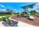Fun playground area with slides, benches, and green space for enjoyment at 20296 Bandera Pl, Venice, FL 34293