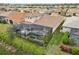 Backyard aerial view with screened-in pool, patio area, and lush landscaping in a residential neighborhood at 20296 Bandera Pl, Venice, FL 34293