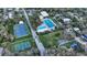 Aerial view of community tennis courts, playground and pool in a residential neighborhood at 2264 Floyd St, Sarasota, FL 34239