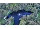 Scenic aerial view of a serene lake with a fountain surrounded by lush trees and walking paths at 2264 Floyd St, Sarasota, FL 34239