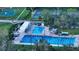 Aerial view of community basketball and tennis courts plus swimming pool with diving boards at 2264 Floyd St, Sarasota, FL 34239