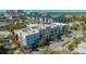 A vibrant aerial view of colorful buildings and a rooftop pool showcases upscale urban living near the waterfront at 2264 Floyd St, Sarasota, FL 34239