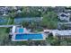 Aerial view of community pool and tennis courts with parking in a residential neighborhood at 2264 Floyd St, Sarasota, FL 34239