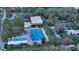 Aerial image of community pool with parking and tennis courts in a wooded area at 2264 Floyd St, Sarasota, FL 34239