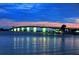 A majestic bridge illuminated at night over tranquil waters creates a striking and scenic waterfront at 2264 Floyd St, Sarasota, FL 34239