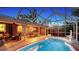 Relaxing backyard with screened-in pool, covered lanai with pool table, and ample lounging space at 2264 Floyd St, Sarasota, FL 34239