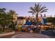 Lively restaurant exterior with outdoor seating, palm trees, and festive lighting at twilight at 2264 Floyd St, Sarasota, FL 34239