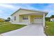Home featuring a covered carport and garage with a driveway and well maintained lawn at 4531 13Th E St, Ellenton, FL 34222