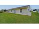 Exterior view of the home with vinyl siding, showing the side yard and ample greenery at 4531 13Th E St, Ellenton, FL 34222