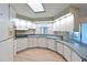 Functional kitchen with white cabinets, updated appliances, and a breakfast bar at 4531 13Th E St, Ellenton, FL 34222