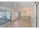 Open-concept living and dining area with modern light fixtures and sliding glass doors at 4531 13Th E St, Ellenton, FL 34222