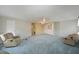 Spacious living room with plush carpeting, ceiling fan, and built-in cabinetry at 4531 13Th E St, Ellenton, FL 34222