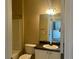 Bathroom featuring a white toilet, sink and shower with dark countertops at 4802 51St W St # 521, Bradenton, FL 34210