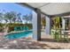 Covered patio with pool and deck, green seating, and outdoor bar at 517 Blue Heron Dr, Anna Maria, FL 34216