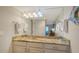 Bright bathroom with a large mirror, unique lighting, and a granite countertop at 5311 Gulf Of Mexico Dr # 3, Longboat Key, FL 34228