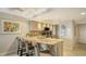 Well-lit kitchen featuring bar seating, granite countertops, and modern appliances at 5311 Gulf Of Mexico Dr # 3, Longboat Key, FL 34228