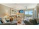 Comfortable living room with a large sliding glass door to the water and a ceiling fan at 5311 Gulf Of Mexico Dr # 3, Longboat Key, FL 34228