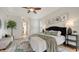 Main bedroom boasts tray ceilings and a serene palette with ensuite bathroom at 5401 Oak Grove Ct, Sarasota, FL 34233