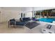 Cozy outdoor living area featuring stylish furniture, a modern fire pit, and a refreshing pool nearby at 6605 Gulf Dr, Holmes Beach, FL 34217