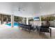 Stylish outdoor living space with comfortable seating, ceiling fans, and a view of the sparkling pool at 6605 Gulf Dr, Holmes Beach, FL 34217